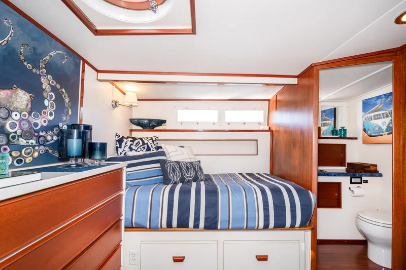 Slide: The Image of 1965 Chris-Craft 57 Constellation cabin with striped bedding and nautical decor. - 36
