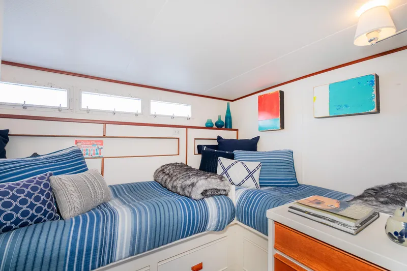 Slide: The Image of Cozy cabin interior of 1965 Chris-Craft 57 Constellation with twin beds and nautical decor. - 46