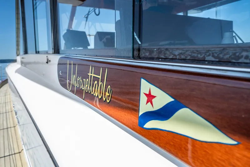 Slide: The Image of 1965 Chris-Craft 57 Constellation yacht with "Unforgettable" nameplate and nautical flag. - 6