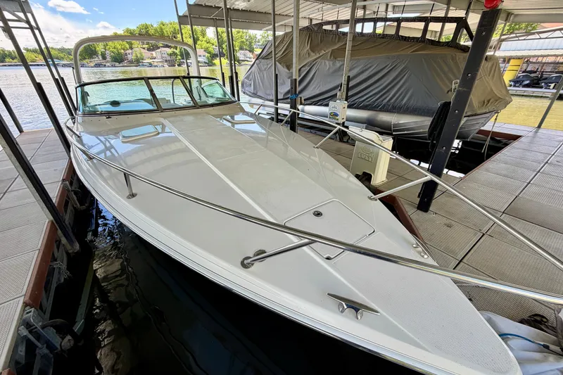 Slide: The Image of 2003 Formula 330 Sun Sport boat docked, featuring sleek design and spacious deck. - 12
