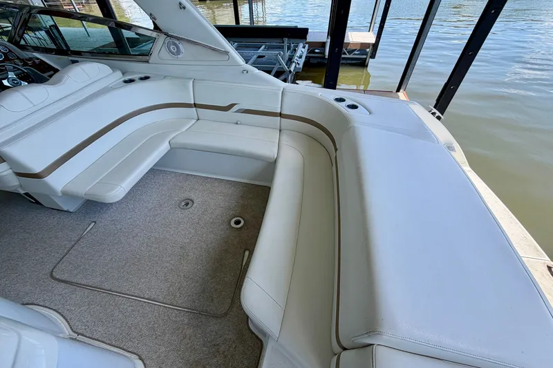 Slide: The Image of 2003 Formula 330 Sun Sport boat interior with white seating and lake view. - 14