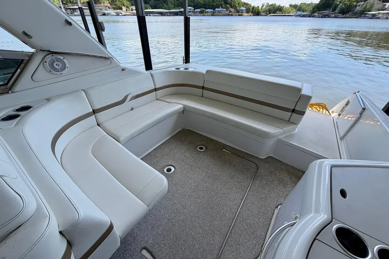 Slide: The Image of 2003 Formula 330 Sun Sport boat interior with white seating and lake view. - 15
