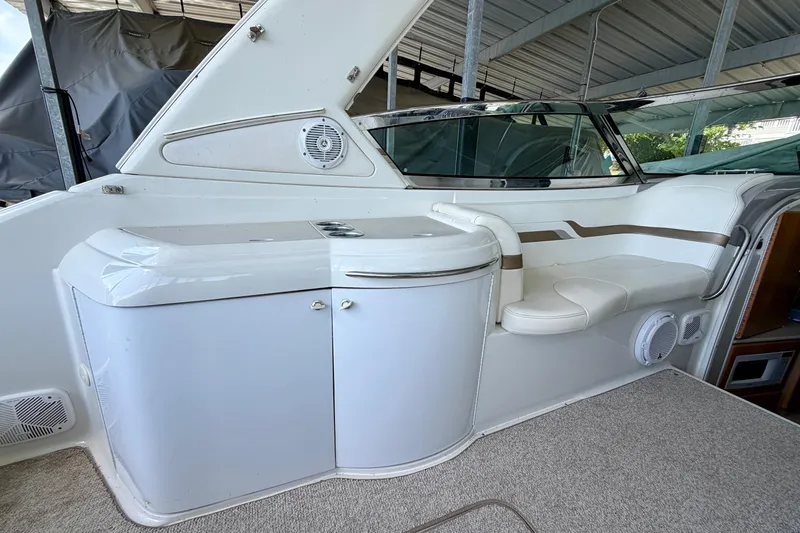 Slide: The Image of 2003 Formula 330 Sun Sport boat interior with white seating and storage area. - 17