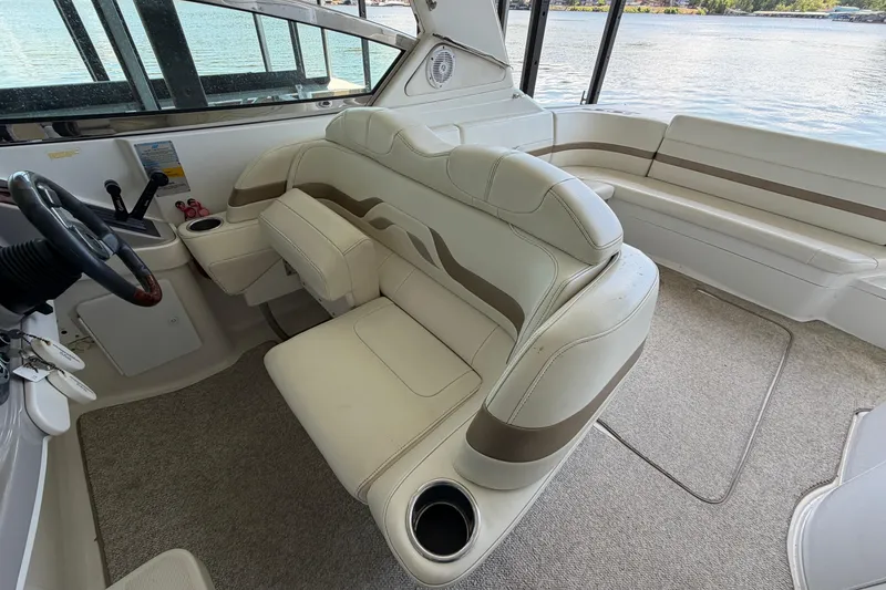 Slide: The Image of Interior of a 2003 Formula 330 Sun Sport boat with plush seating and steering wheel. - 22