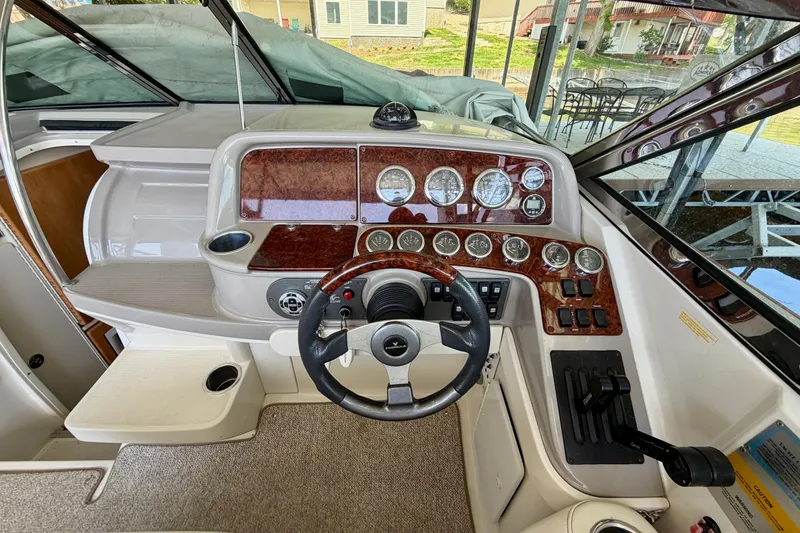 Slide: The Image of 2003 Formula 330 Sun Sport boat dashboard with steering wheel and instrument panel. - 23
