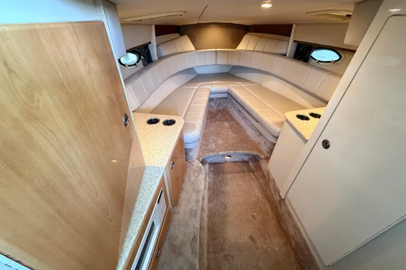 Slide: The Image of Interior of a 2003 Formula 330 Sun Sport boat with beige seating and wood accents. - 30