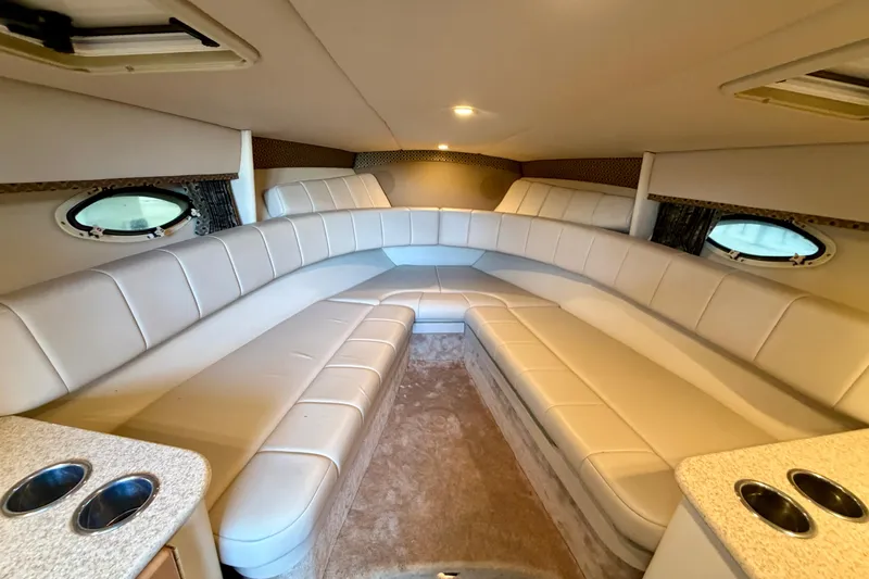 Slide: The Image of Luxurious interior of 2003 Formula 330 Sun Sport boat with plush seating and porthole windows. - 31