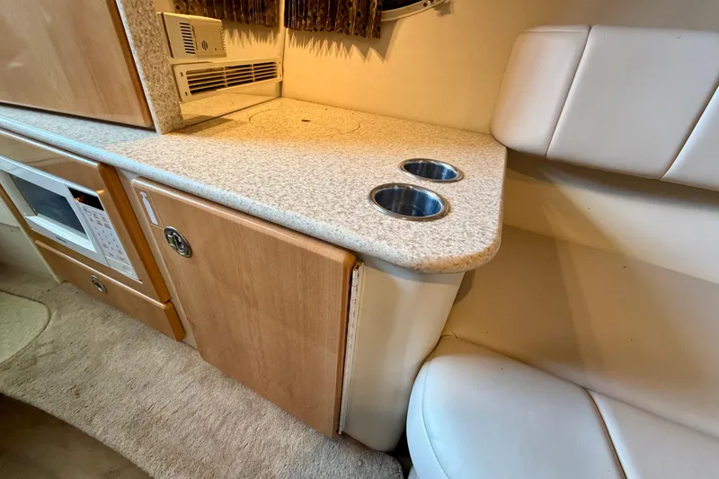 Slide: The Image of Interior of 2003 Formula 330 Sun Sport boat with kitchenette and seating area. - 35