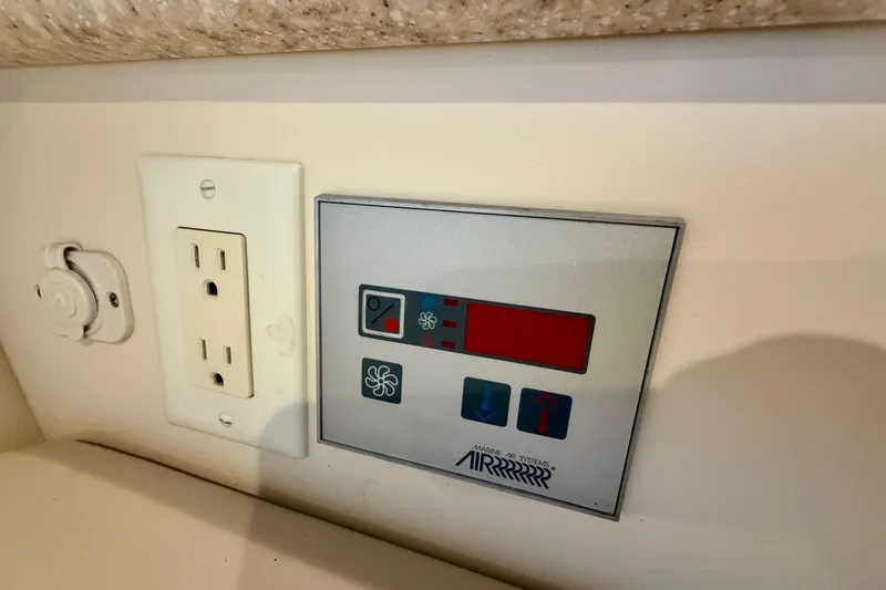 Slide: The Image of Control panel and outlet on 2003 Formula 330 Sun Sport boat interior. - 37