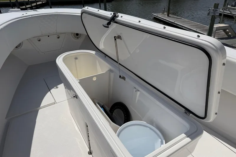 Slide: The Image of Open storage compartment on 2021 Competition 31 boat, dockside view. - 10