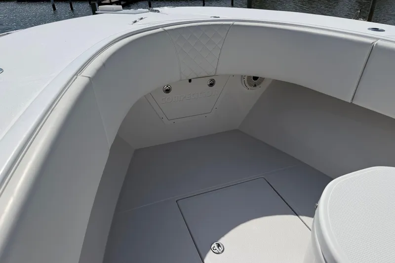 Slide: The Image of Interior of a 2021 Competition 31 boat, featuring sleek white seating and storage compartments. - 11