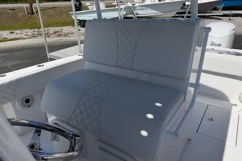 Slide: The Image of 2021 Competition 31 boat with white cushioned seating and steering wheel. - 12