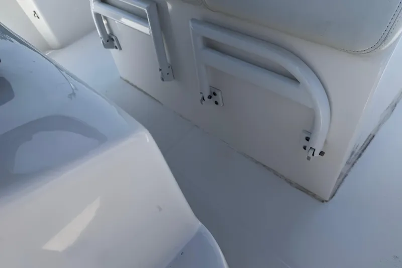 Slide: The Image of Interior of a 2021 Competition 31 boat, featuring white seating and storage compartments. - 13
