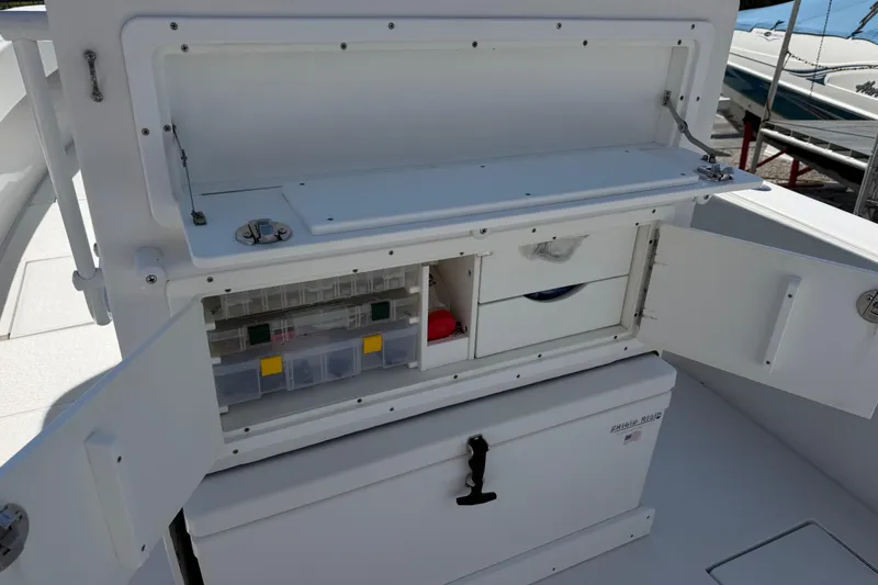 Slide: The Image of Open storage compartments on a 2021 Competition 31 boat, showcasing organized fishing gear. - 16