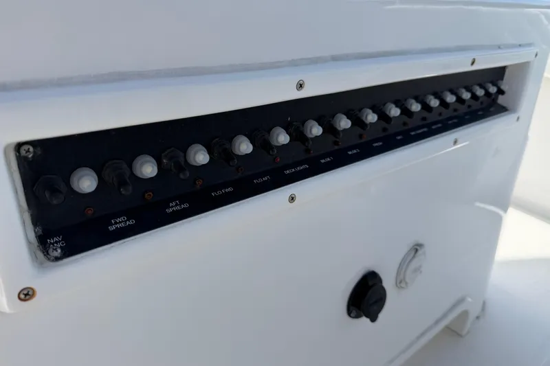 Slide: The Image of Control panel of a 2021 Competition 31 boat with multiple switches. - 23