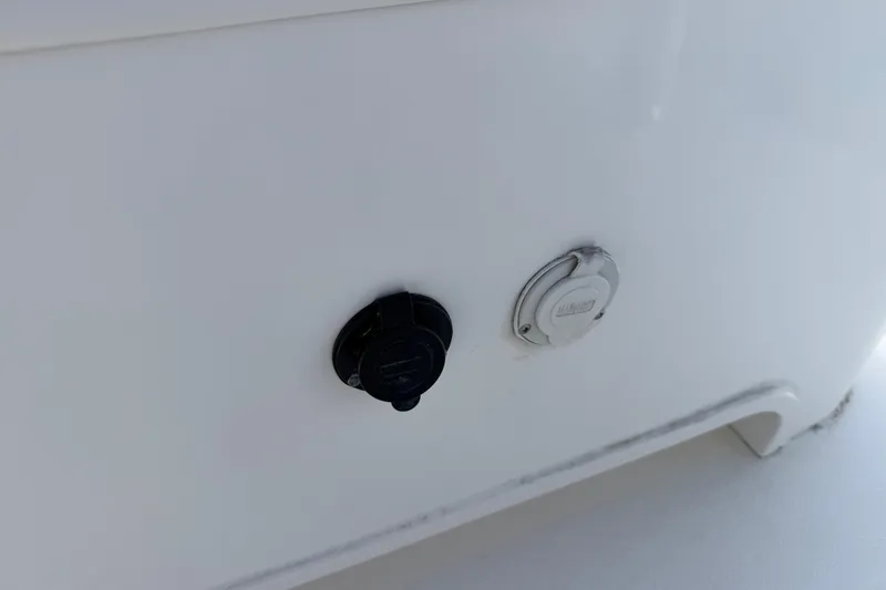 Slide: The Image of 2021 Competition 31 boat detail showing two circular ports on white surface. - 24