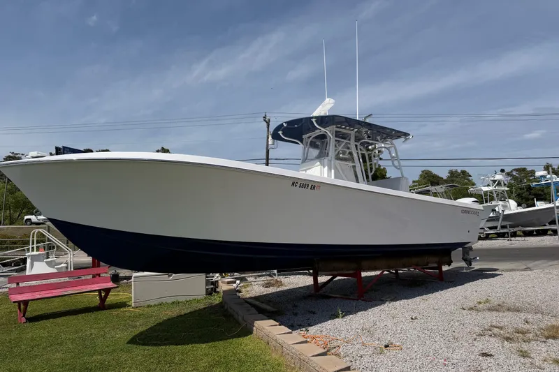 Slide: The Image of 2021 Competition 31 boat on display, white hull, blue bottom, outdoor setting. - 3