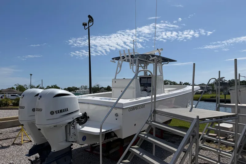 Slide: The Image of 2021 Competition 31 boat with twin Yamaha engines on display outdoors. - 8