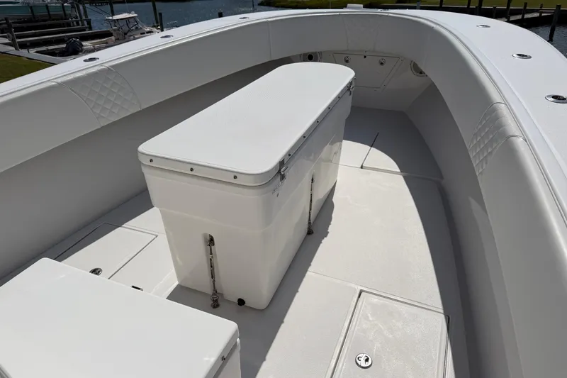 Slide: The Image of 2021 Competition 31 boat interior with cushioned seating and storage compartment. - 9