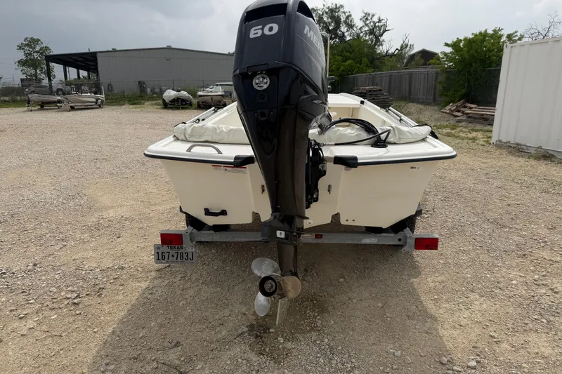 Slide: The Image of 2015 Mako Pro Skiff 17 CC boat with outboard motor on a trailer. - 2