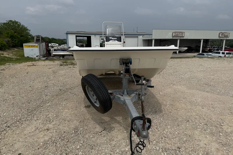 Slide: The Image of 2015 Mako Pro Skiff 17 CC on trailer in gravel lot, overcast sky. - 5