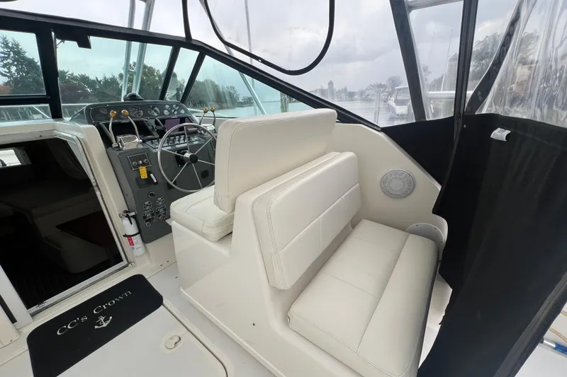 Slide: The Image of 1993 Tiara Yachts 3100 Open interior with helm, seating, and controls. - 13