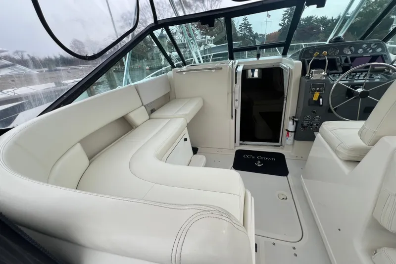 Slide: The Image of Interior of 1993 Tiara Yachts 3100 Open, featuring white seating and helm area. - 14