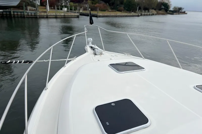Slide: The Image of Bow view of a 1993 Tiara Yachts 3100 Open on calm water. - 29