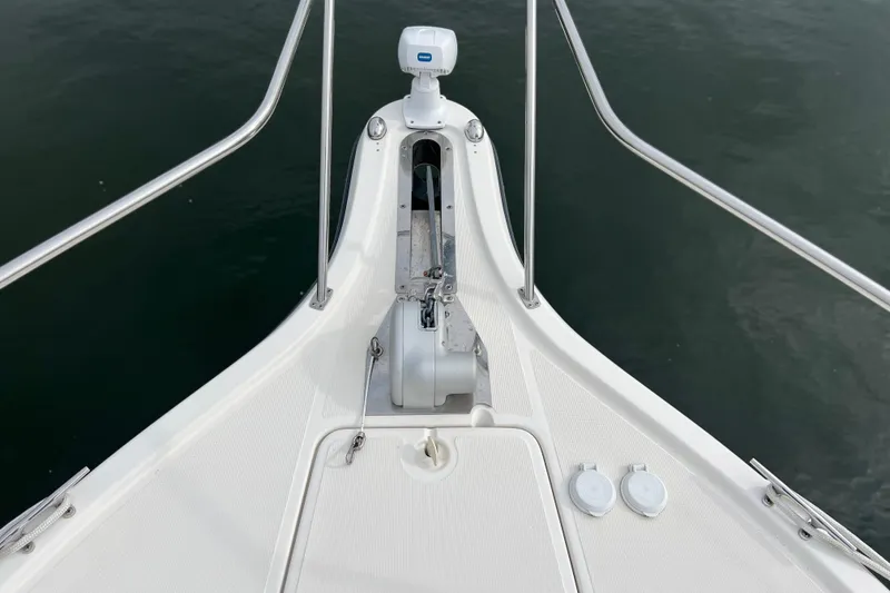 Slide: The Image of Bow of 1993 Tiara Yachts 3100 Open, featuring anchor and railing over water. - 30