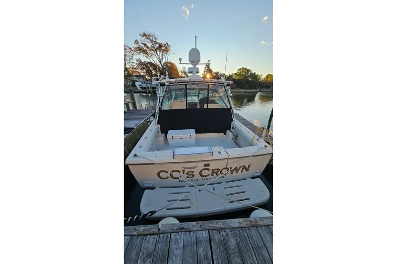 Slide: The Image of 1993 Tiara Yachts 3100 Open docked at sunset, rear view. - 33