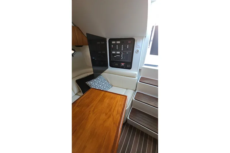 Slide: The Image of Interior of 1993 Tiara Yachts 3100 Open, featuring control panel and wooden table. - 37