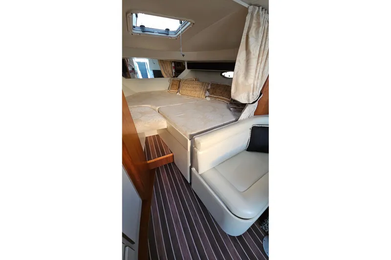 Slide: The Image of 1993 Tiara Yachts 3100 Open cabin interior with cozy seating and elegant decor. - 38