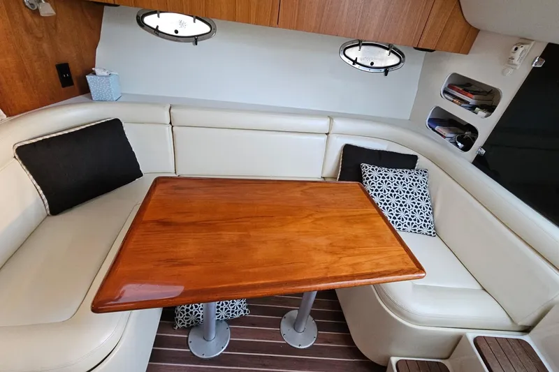 Slide: The Image of Interior of 1993 Tiara Yachts 3100 Open with wooden table and cushioned seating. - 39