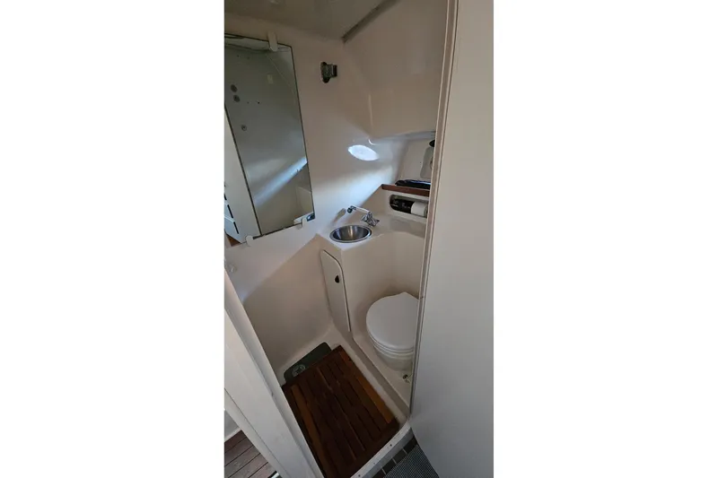 Slide: The Image of 1993 Tiara Yachts 3100 Open bathroom with sink, toilet, and mirror. - 41