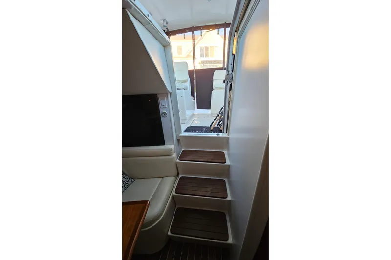 Slide: The Image of Interior view of 1993 Tiara Yachts 3100 Open, featuring wooden steps and seating area. - 42
