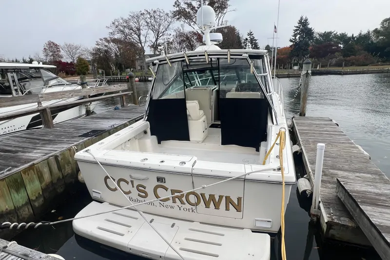 Slide: The Image of 1993 Tiara Yachts 3100 Open docked, rear view, named "CC's Crown," in Babylon, New York marina. - 5