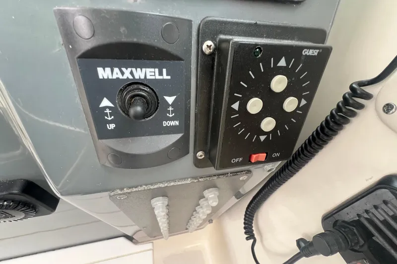 Slide: The Image of Control panel on a 1993 Tiara Yachts 3100 Open, featuring Maxwell and Guest switches. - 9