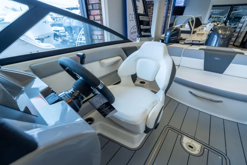Slide: The Image of Interior of 2025 Chaparral 21 SSi OB boat, featuring sleek steering and seating. - 12