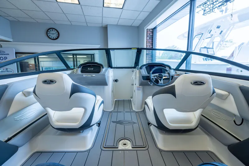 Slide: The Image of Interior view of 2025 Chaparral 21 SSi OB boat, featuring modern seating and dashboard. - 18