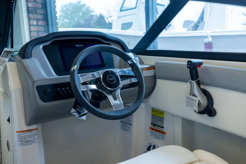 Slide: The Image of Interior view of 2025 Chaparral 21 SSi OB boat dashboard and steering wheel. - 19