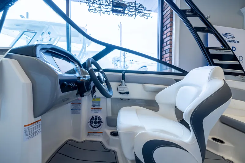 Slide: The Image of Interior view of 2025 Chaparral 21 SSi OB boat, featuring modern helm and seating. - 21