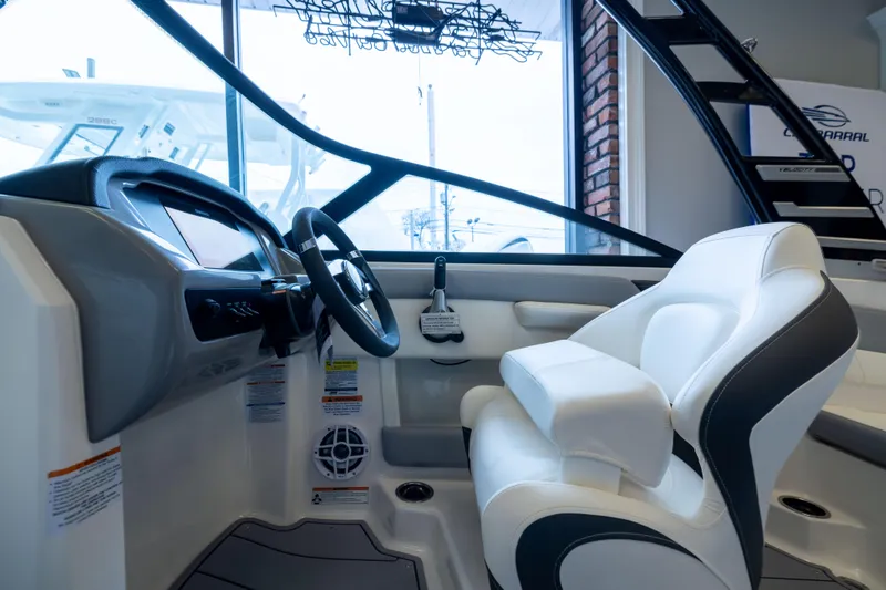 Slide: The Image of Interior view of 2025 Chaparral 21 SSi OB boat cockpit with steering wheel and seating. - 22