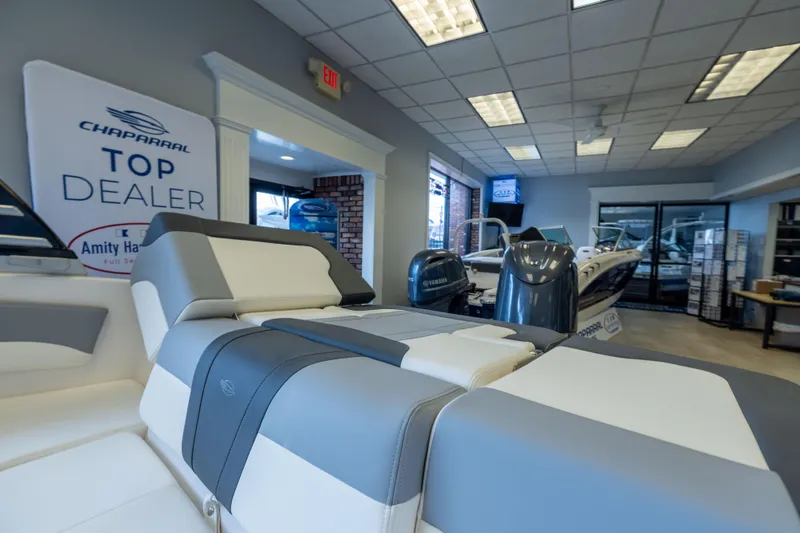 Slide: The Image of 2025 Chaparral 21 SSi OB boat displayed at top dealer showroom. - 25