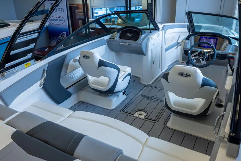 Slide: The Image of 2025 Chaparral 21 SSi OB boat interior with modern seating and sleek dashboard design. - 8