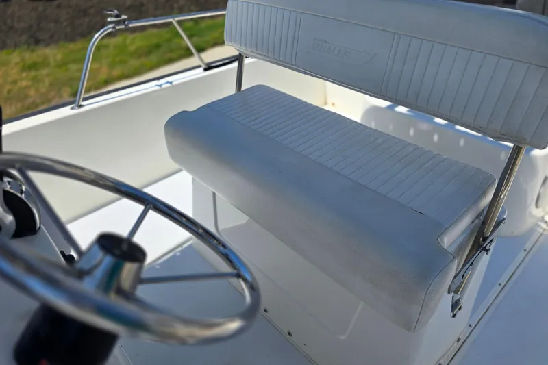 Slide: The Image of 2017 Boston Whaler 210 Montauk boat interior with steering wheel and seating. - 12