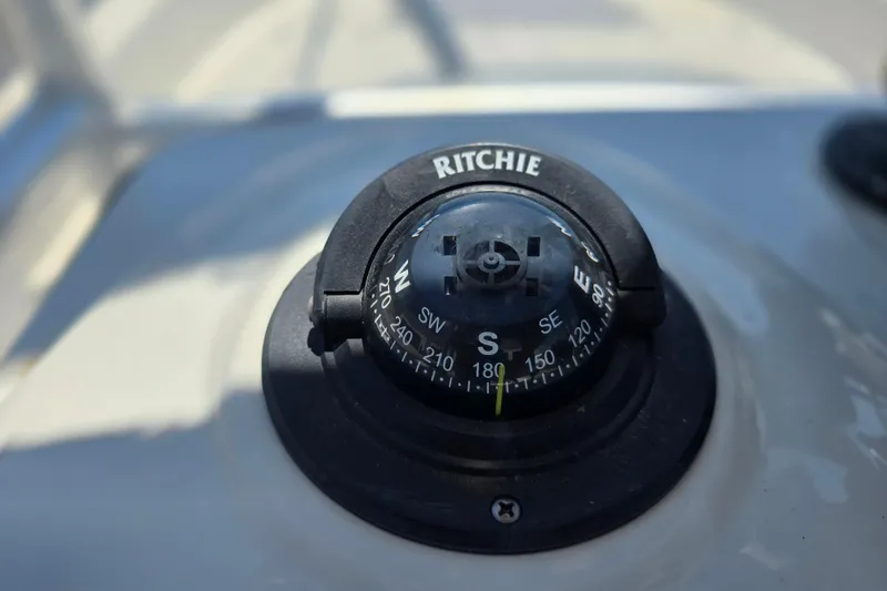 Slide: The Image of Compass on 2017 Boston Whaler 210 Montauk boat dashboard, showing south direction. - 16