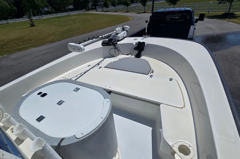 Slide: The Image of 2017 Boston Whaler 210 Montauk boat interior with storage compartments and fishing equipment. - 18