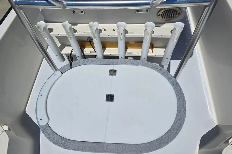 Slide: The Image of 2017 Boston Whaler 210 Montauk boat deck with rod holders and storage compartment. - 19
