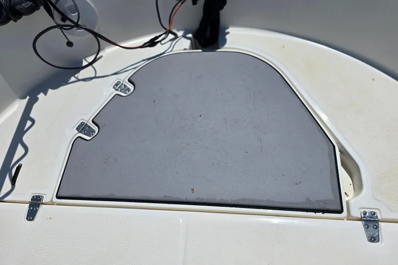 Slide: The Image of 2017 Boston Whaler 210 Montauk boat deck with storage compartment and wiring visible. - 25