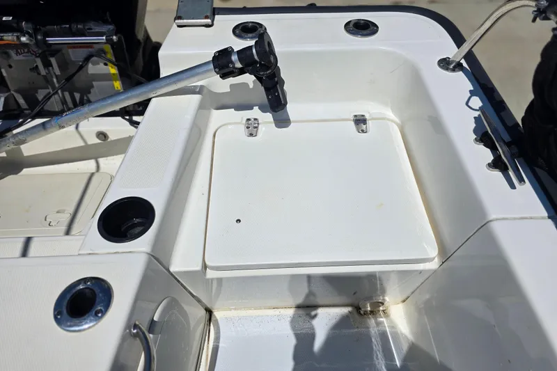 Slide: The Image of 2017 Boston Whaler 210 Montauk boat deck with storage compartment and fishing rod holder. - 26